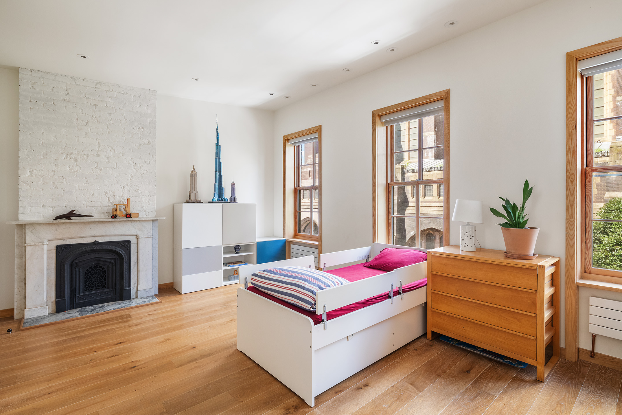 137 St Felix Street Brooklyn, NY 11217 - Photo 8 of 18 a spacious bedroom with a bed and a fireplace