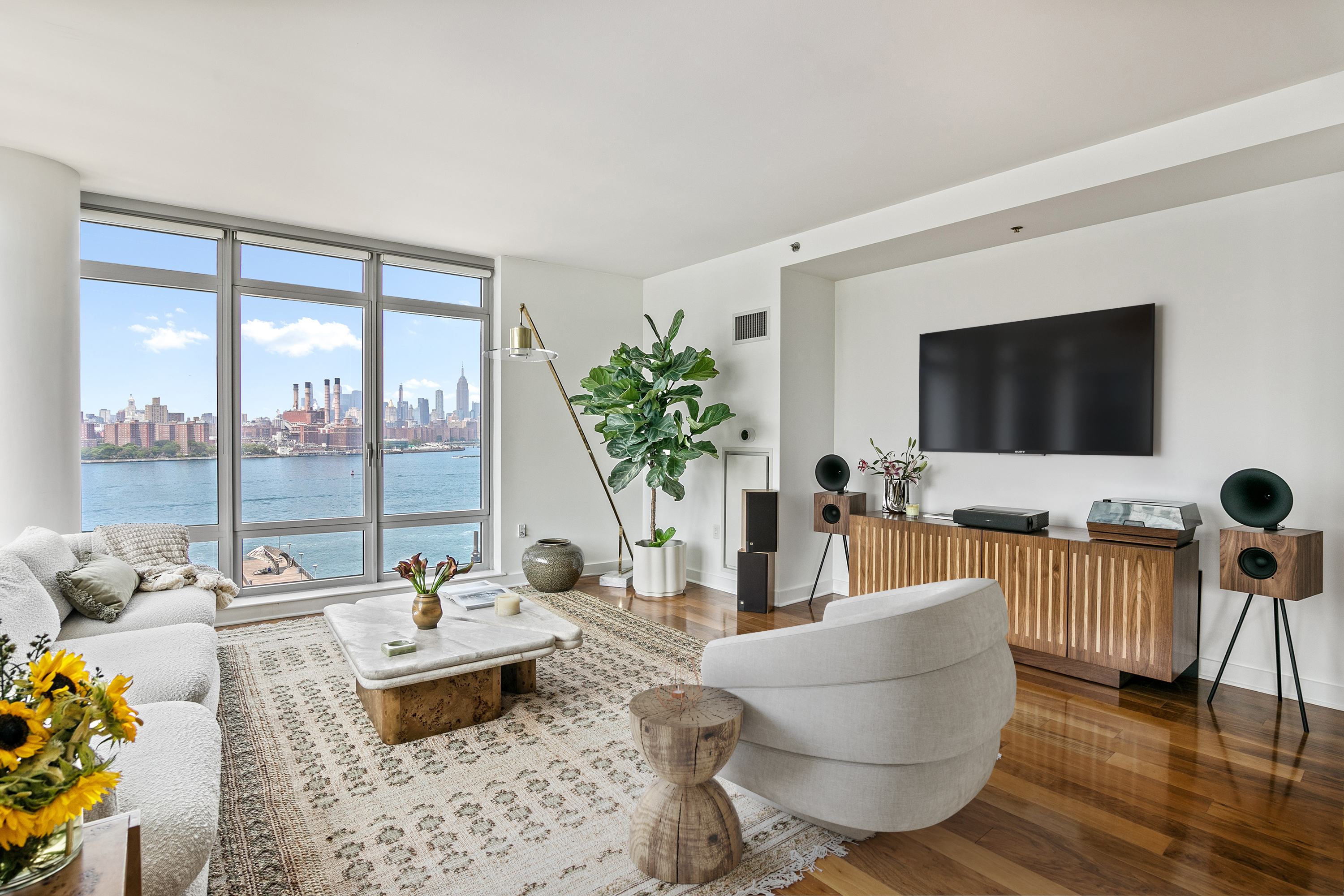 2 Northside Piers, Unit 17A Brooklyn, NY 11249 - Photo 2 of 21 a living room with furniture and a flat screen tv