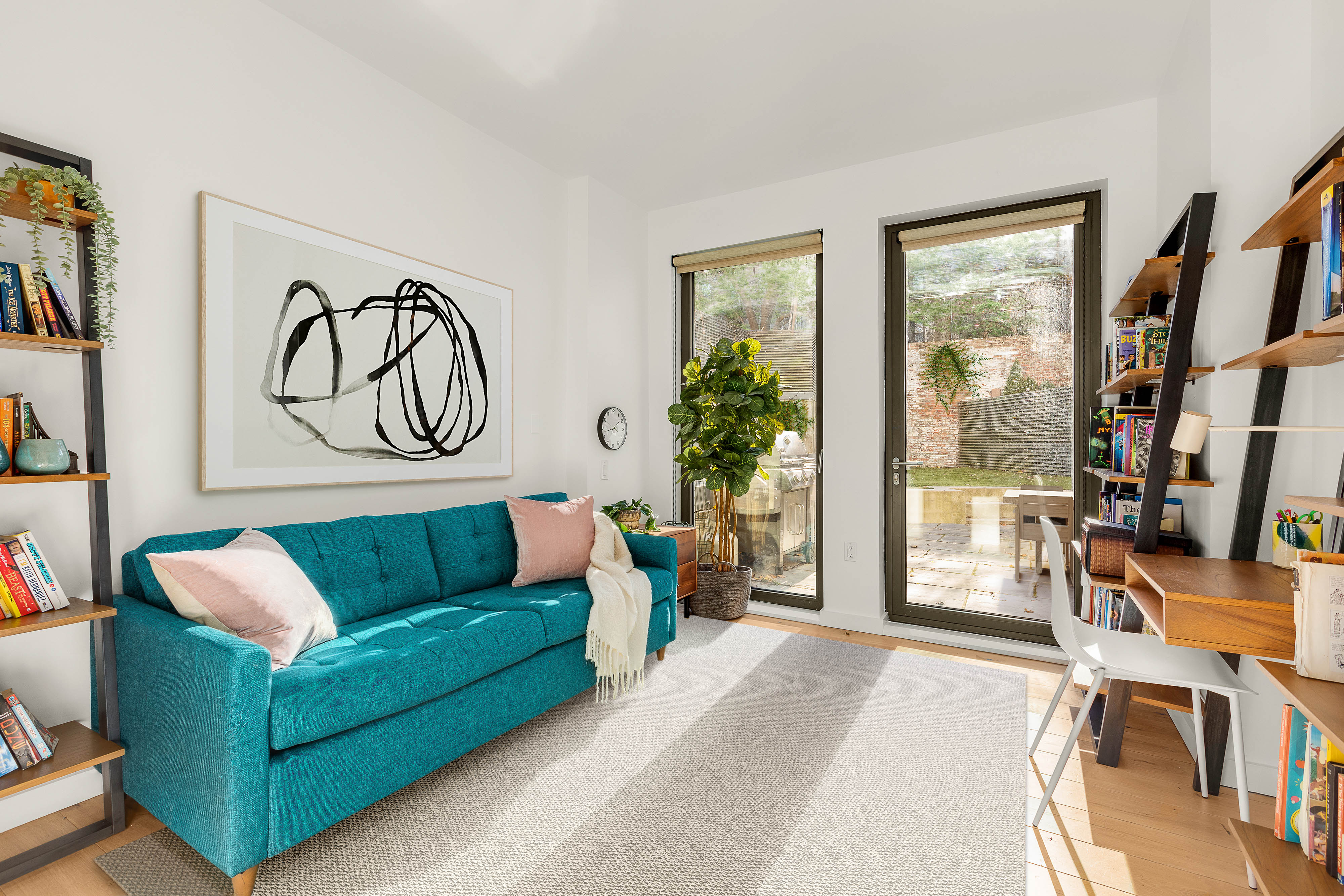 280 Saint Marks Avenue, Unit TH-E Brooklyn, NY 11238 - Photo 9 of 10 a living room with furniture and a large window