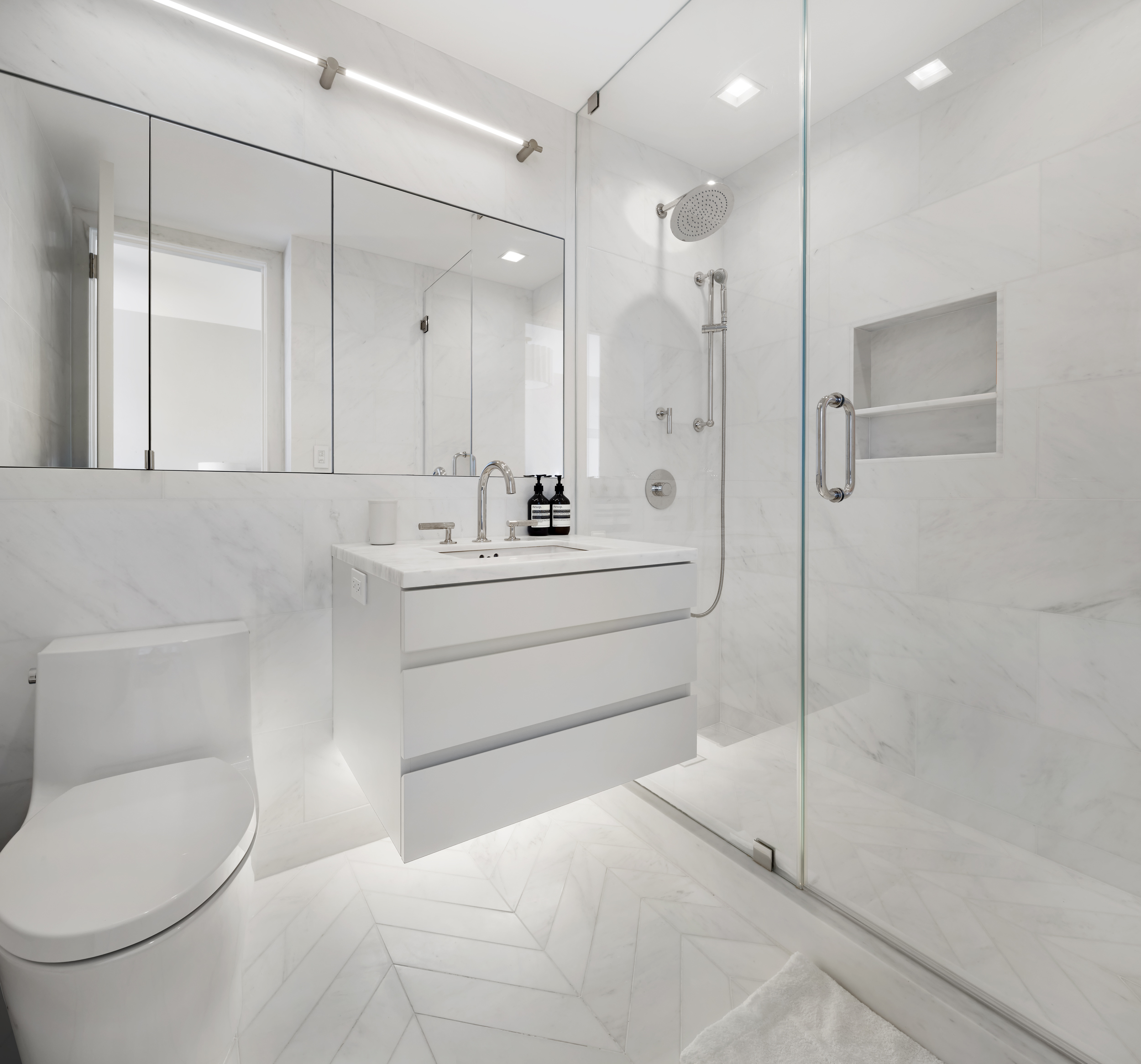 1 Central Park West, Unit 24D Manhattan, NY 10023 - Photo 17 of 19 a bathroom with a sink a toilet and shower
