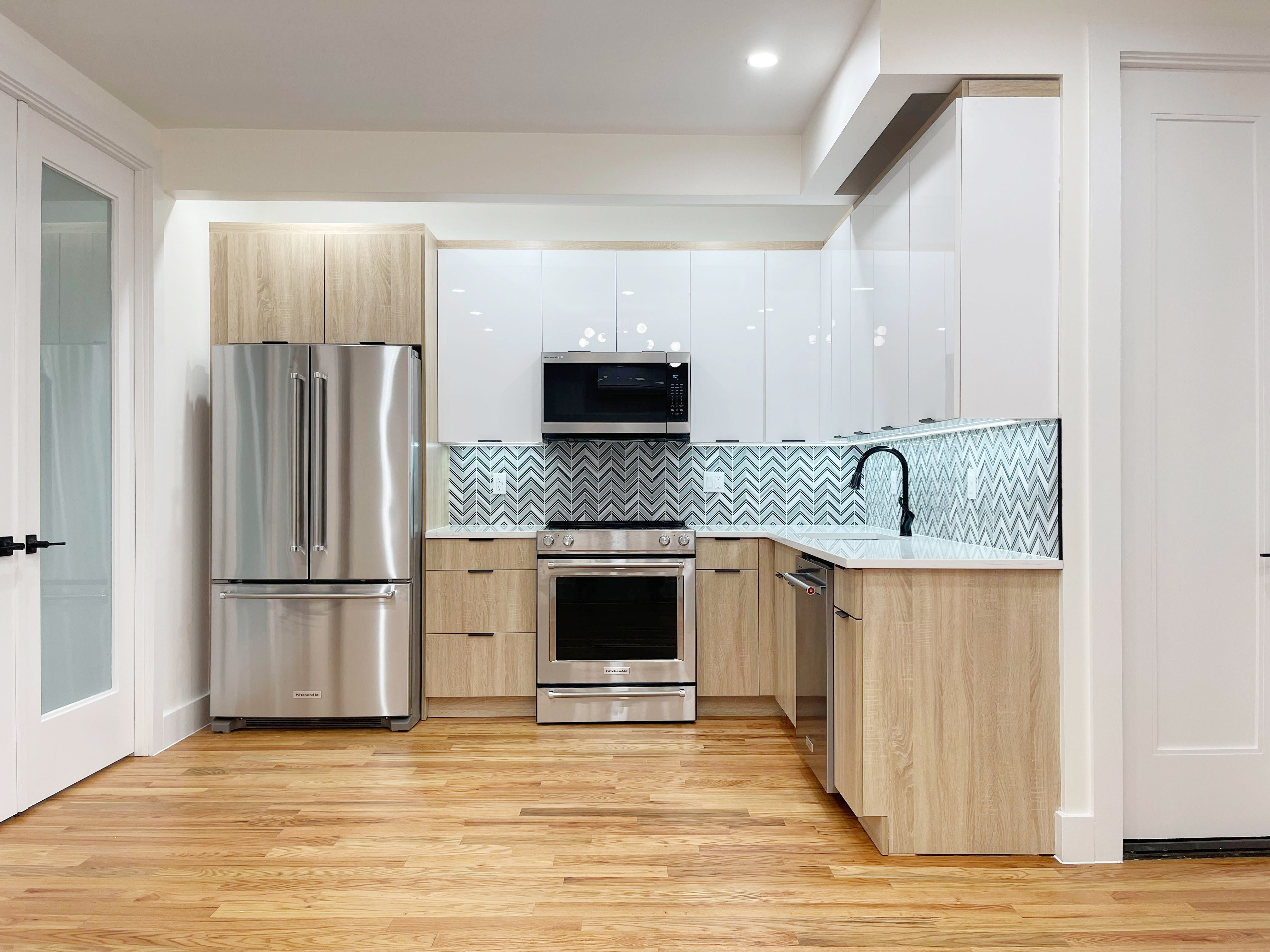 a kitchen with granite countertop a refrigerator and a stove top oven