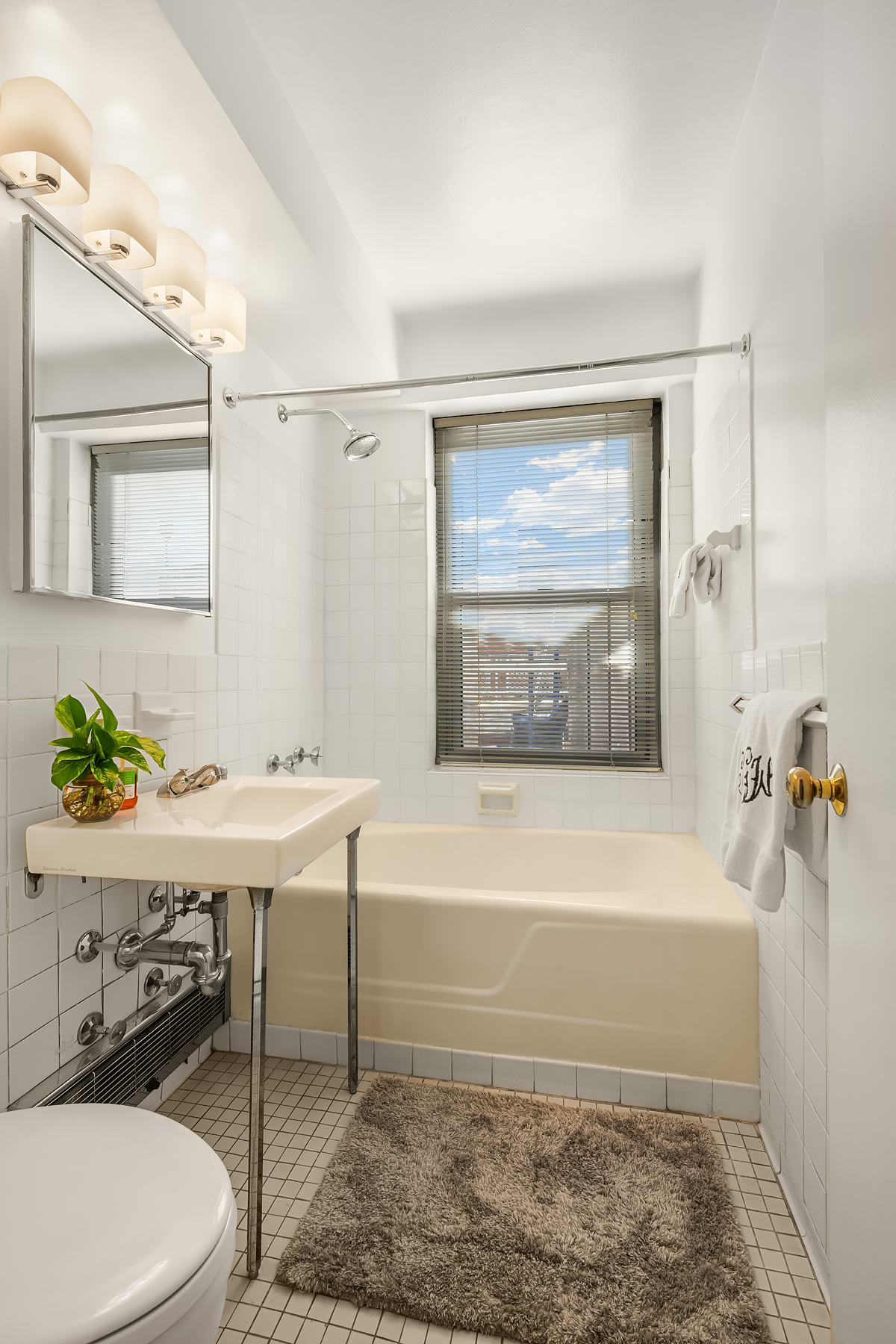 175 West 13th Street, Unit 19C Manhattan, NY 10011 - Photo 15 of 20 a bathroom with a sink a toilet and bathtub
