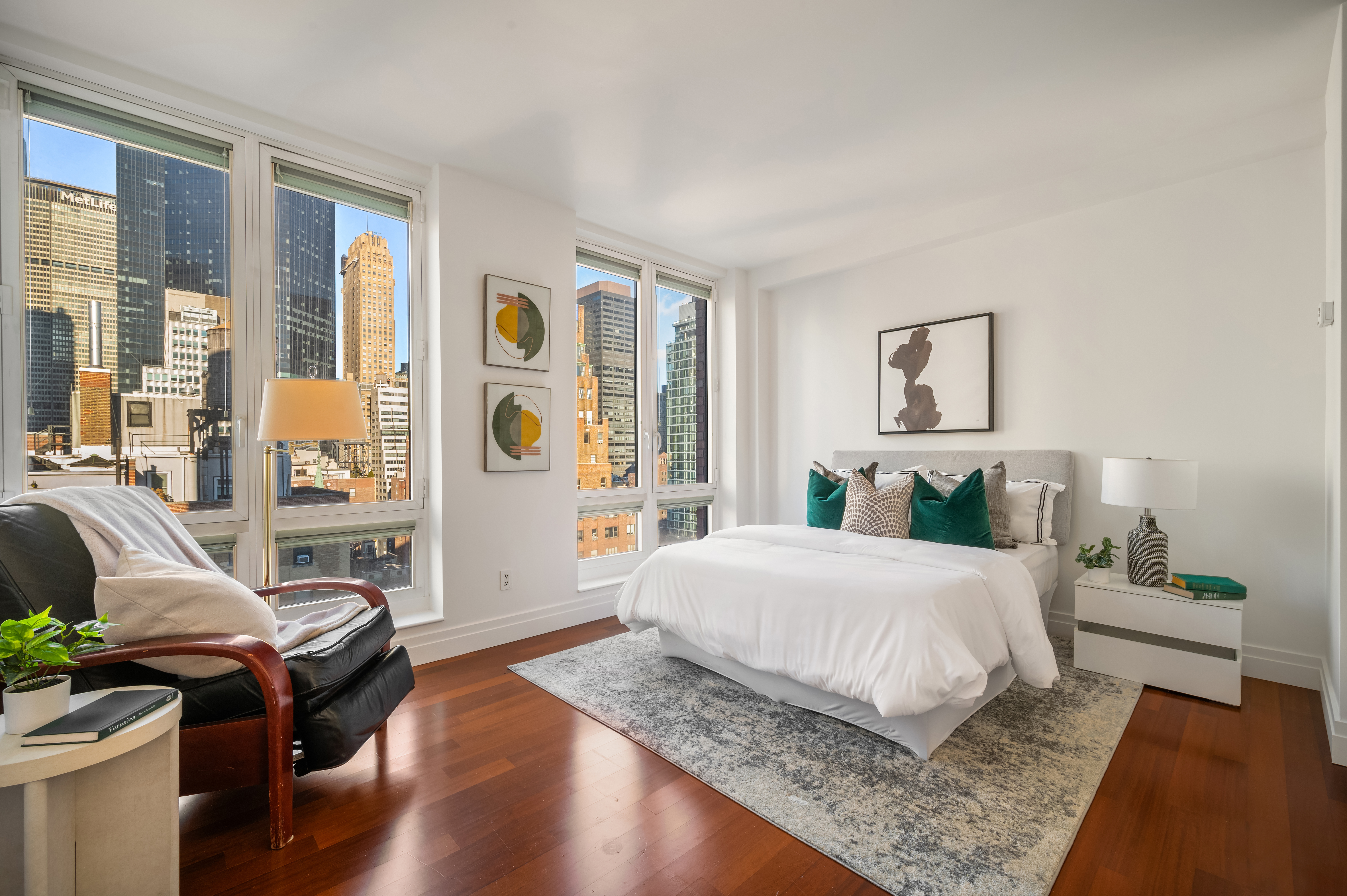 45 Park Avenue, Unit 1801 Manhattan, NY 10016 - Photo 6 of 12 a bedroom with a bed and wooden floor