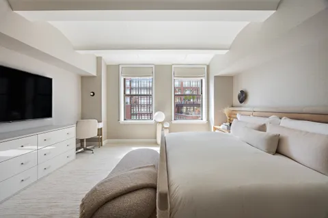 a bathroom with a sink double vanity granite tub shower and a mirror