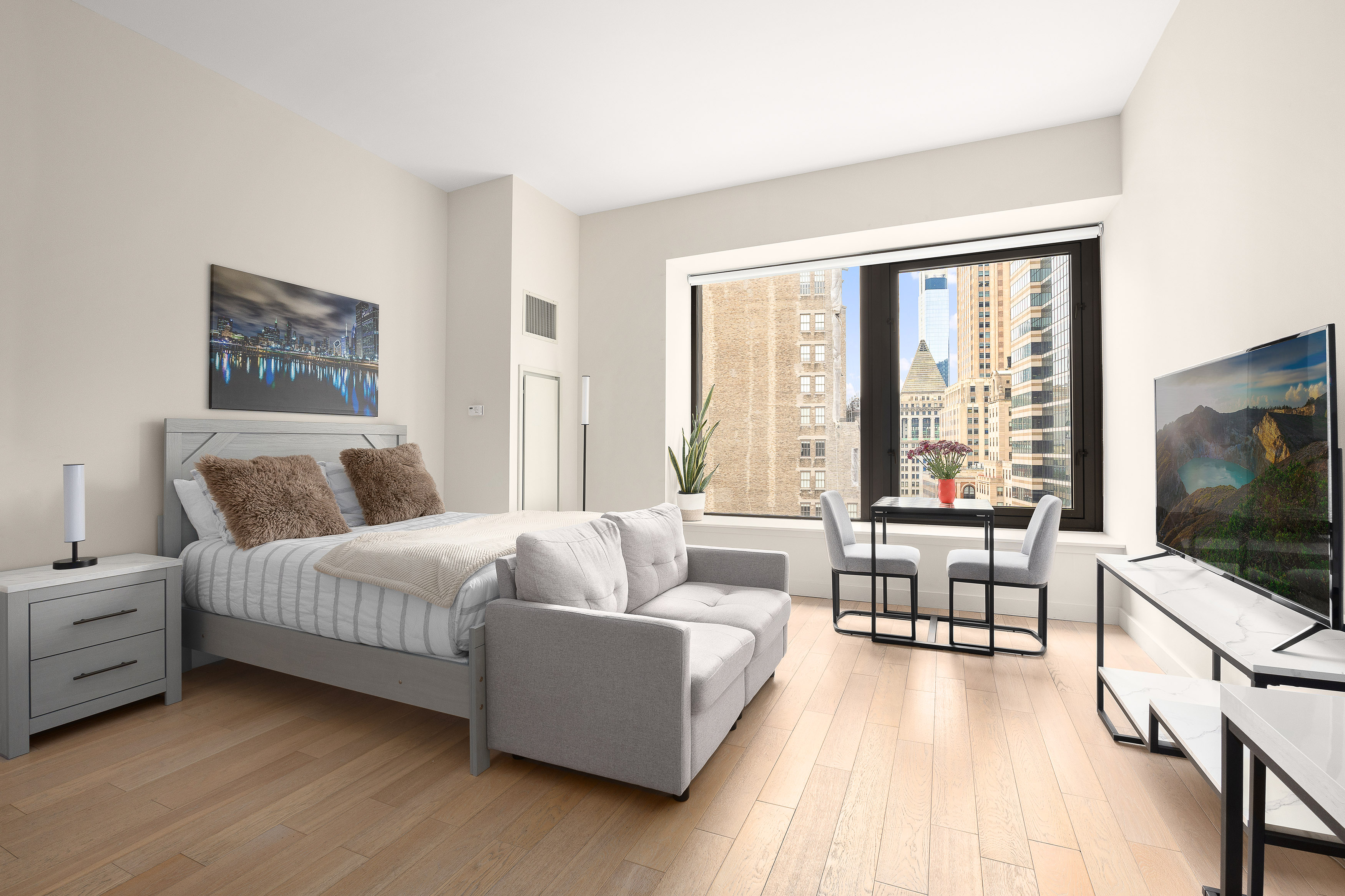 75 Wall Street, Unit 33L Manhattan, NY 10005 - Photo 2 of 5 a living room with furniture and a flat screen tv