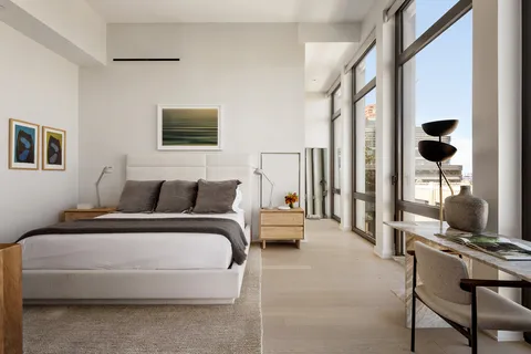 a living room with furniture and a floor to ceiling window