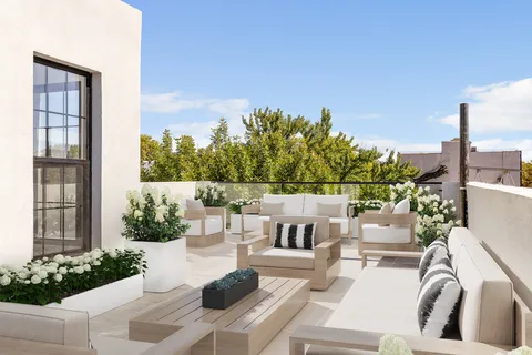 a view of a patio with couches table and chairs and potted plants