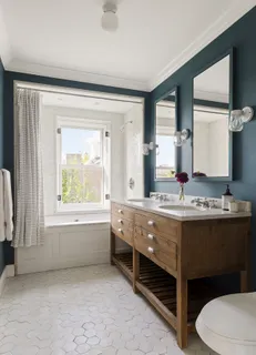 a bathroom with a granite countertop sink mirror and toilet