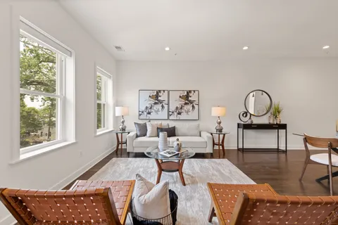 a living room with furniture a window and a table