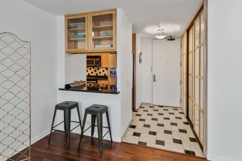 a dining room with furniture and wooden floor