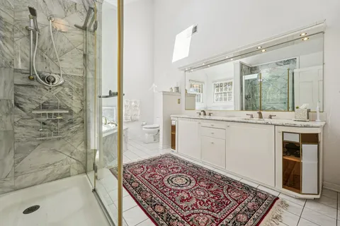 a bathroom with a sink a mirror and a shower