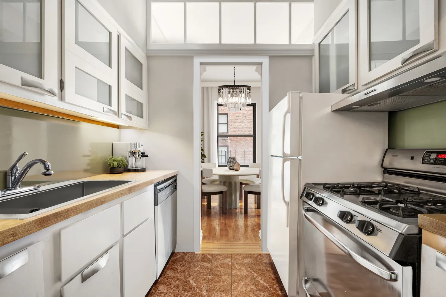 77 Park Avenue, Unit 6G Manhattan, NY 10016 - Photo 4 of 6 a kitchen with stainless steel appliances granite countertop a sink stove and refrigerator