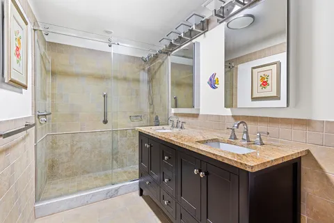 a bathroom with a granite countertop sink mirror and double