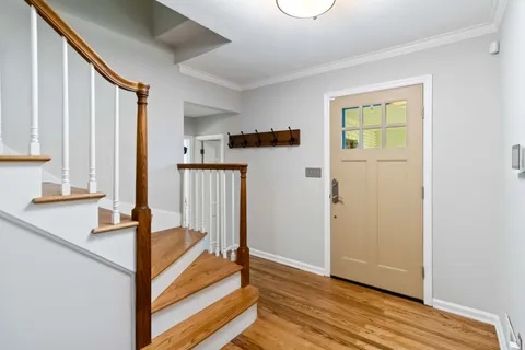 a view of hallway with wooden floor and stairs