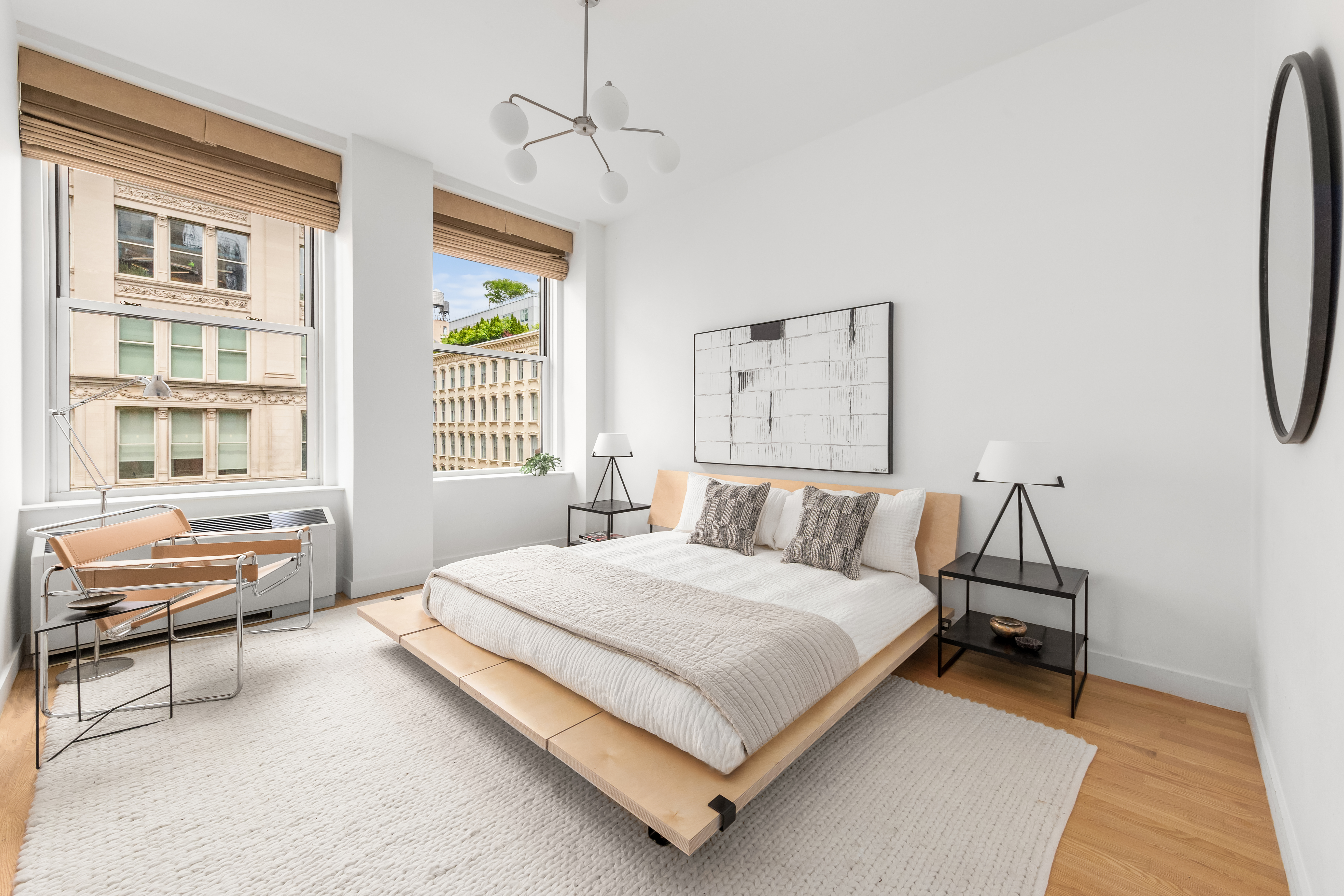 60 West 20th Street, Unit 4E Manhattan, NY 10011 - Photo 8 of 16 a bedroom with a bed a couch and a window