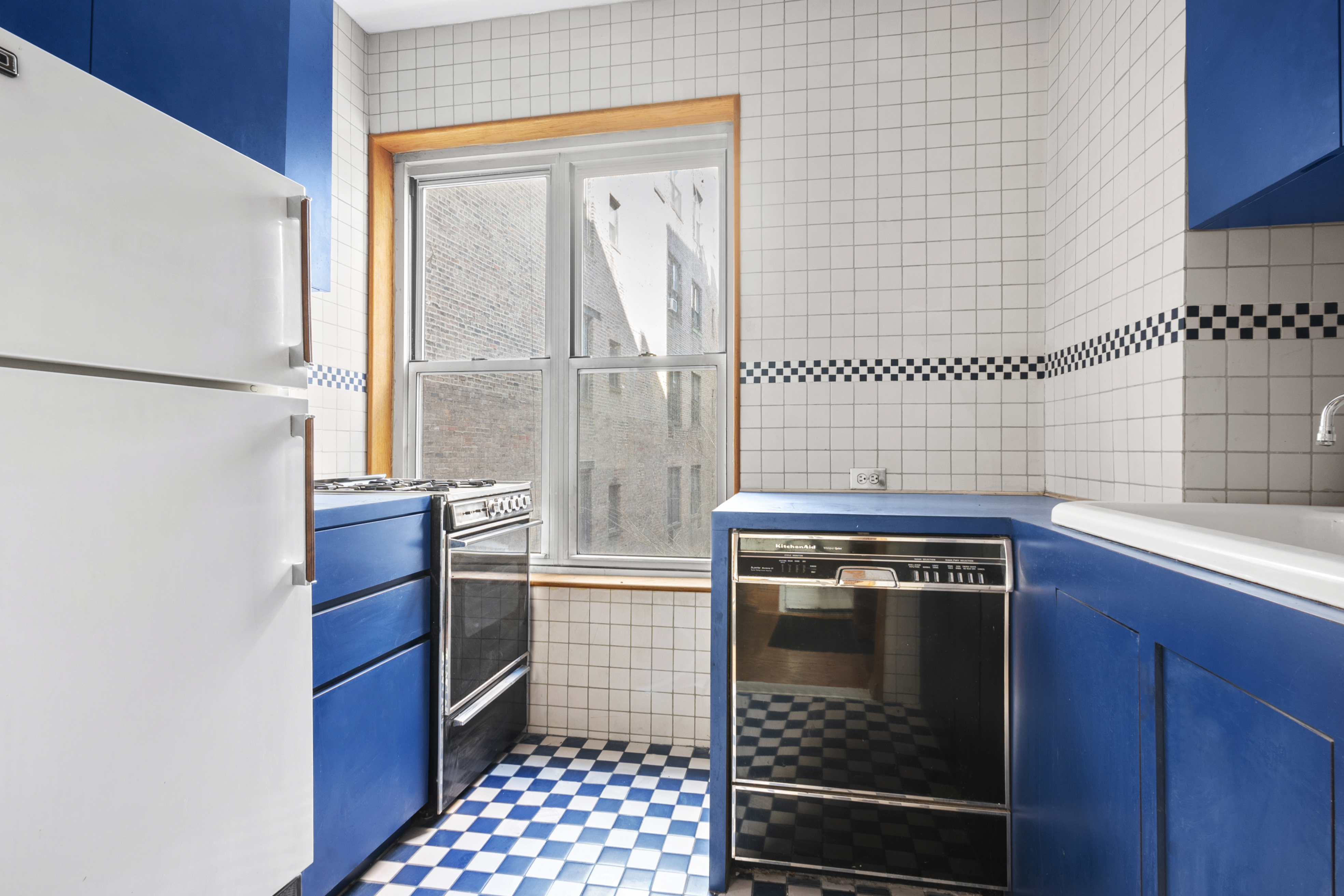 306 West 4th Street, Unit B1B2 Manhattan, NY 10014 - Photo 4 of 9 a kitchen with stainless steel appliances granite countertop a stove a refrigerator and a sink