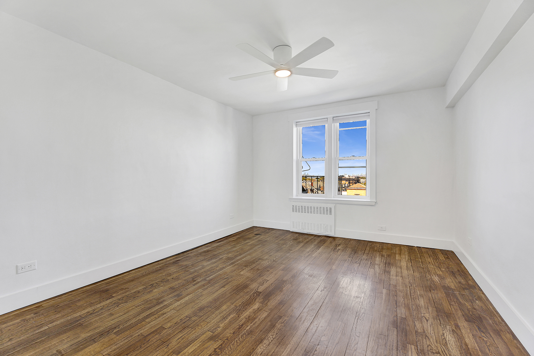 125 Beach 124th Street, Unit 5K Queens, NY 11694 - Photo 14 of 21 wooden floor in an empty room with a window
