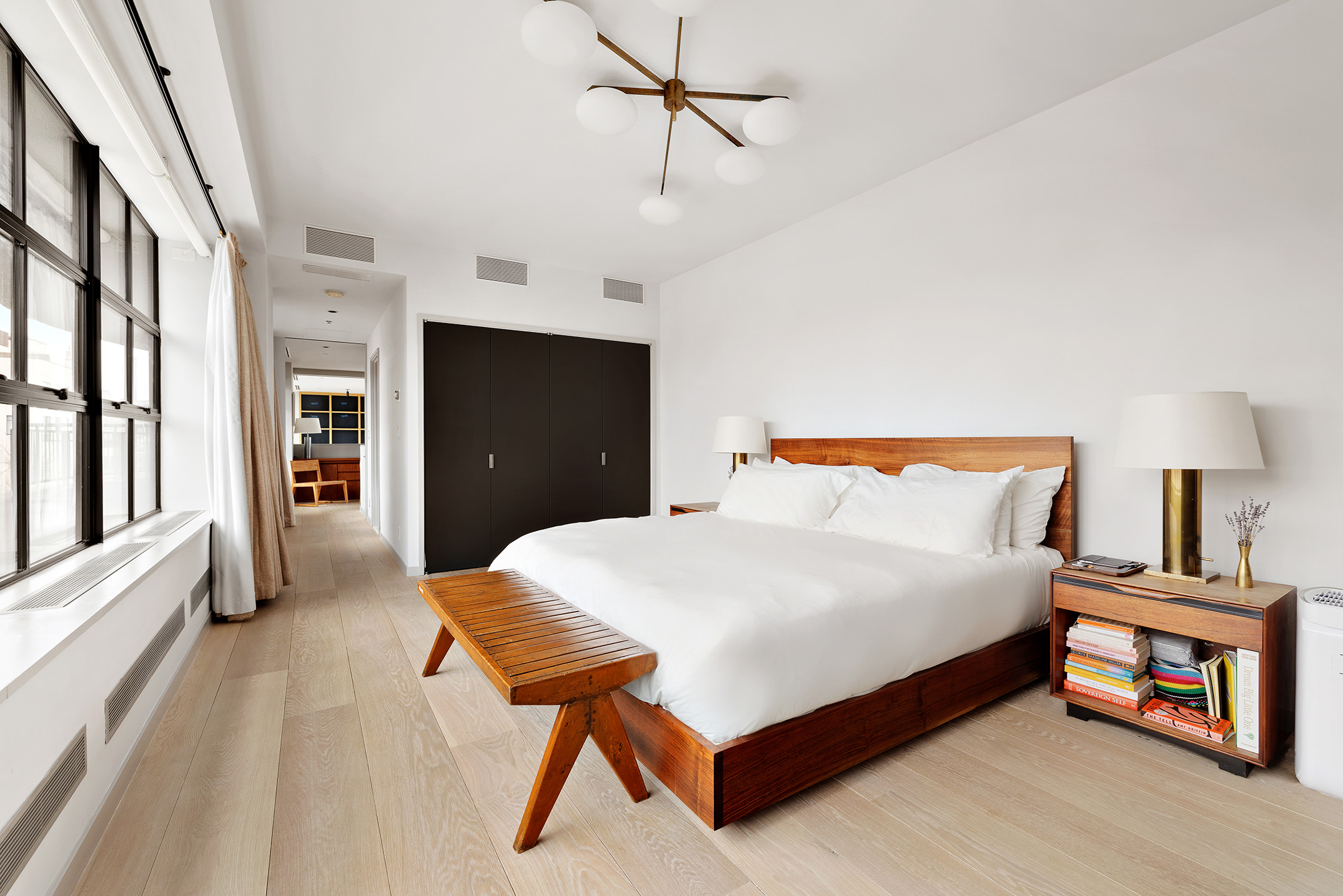 456 West 19th Street, Unit PHG Manhattan, NY 10011 - Photo 5 of 12 a bedroom with a bed and a lamp on dresser