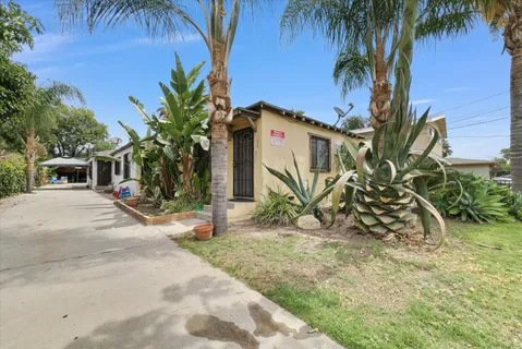 a view of a house with a yard and sitting area