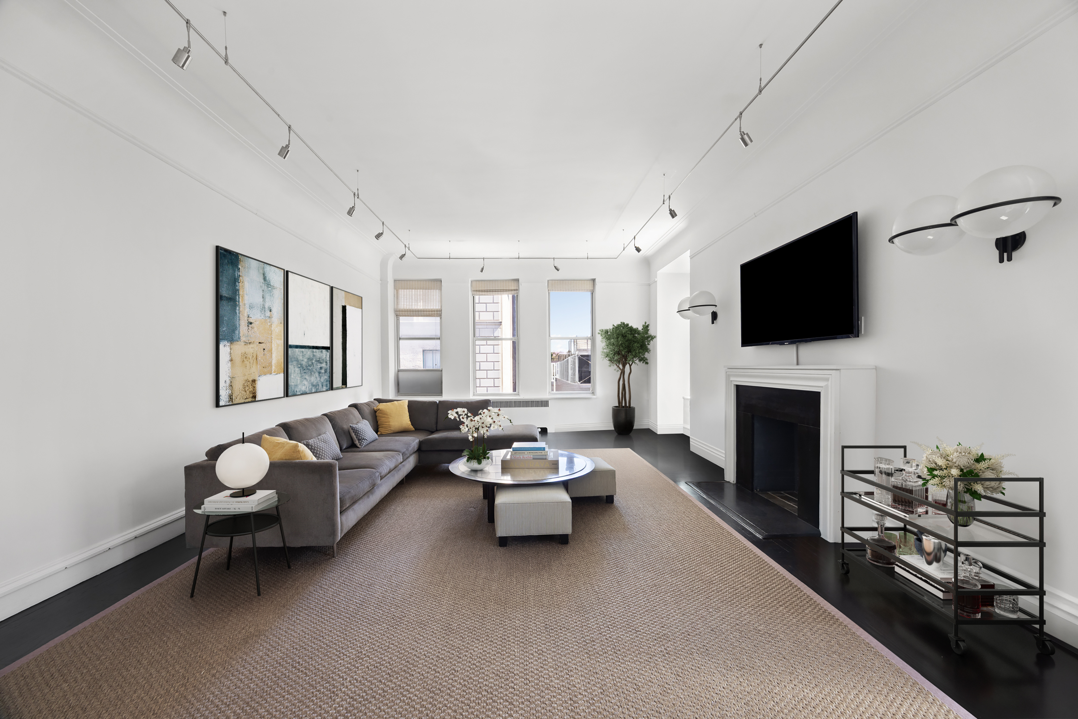 180 West 58th Street, Unit 11A Manhattan, NY 10019 - Photo 2 of 17 a living room with furniture a fireplace and a flat screen tv