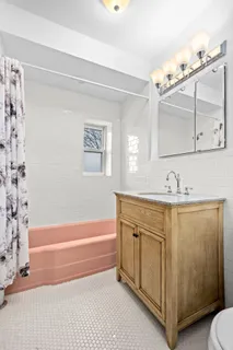 a bathroom with a sink a mirror and a bathtub