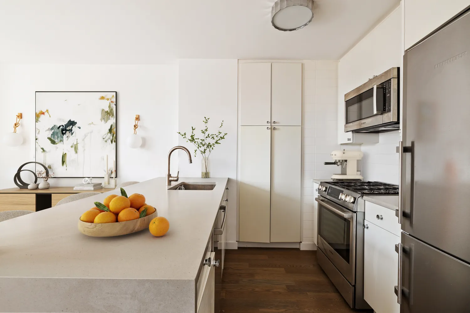 a kitchen with stainless steel appliances granite countertop a sink a stove and a refrigerator