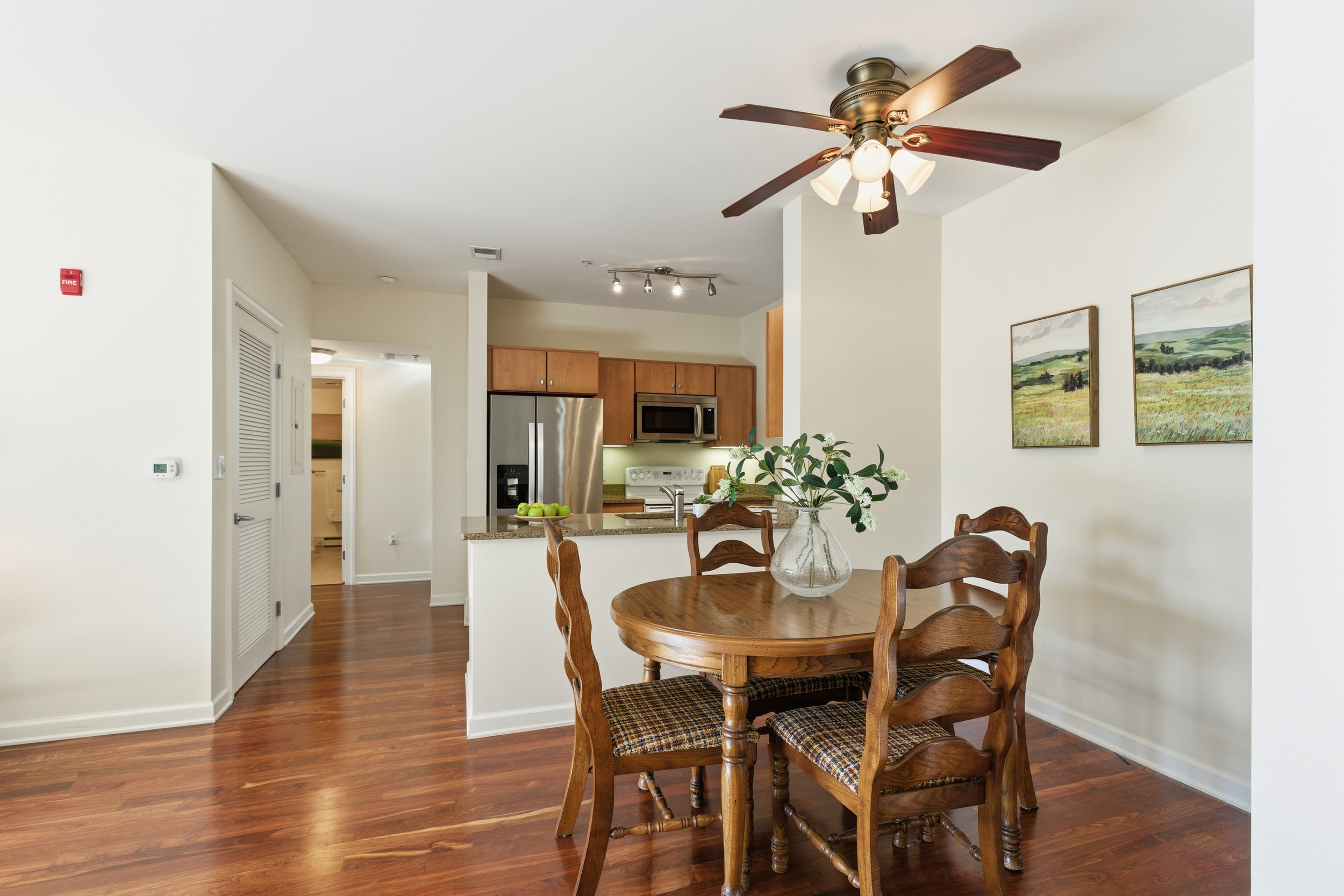 Repton Circle, Unit 3204 Watertown, MA 02472 - Photo 5 of 18 a view of a dining room with furniture and a chandelier fan