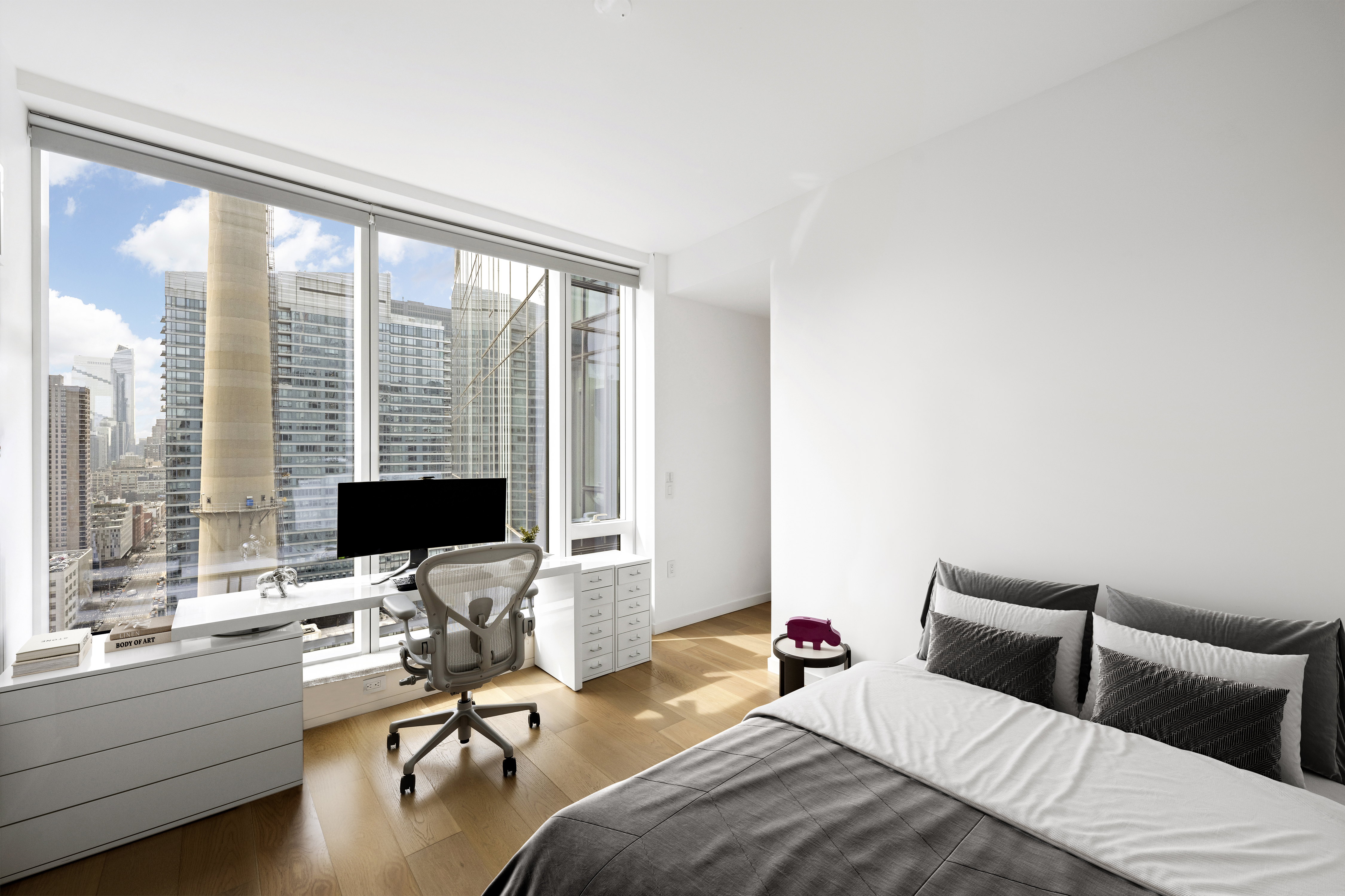 1 West End Avenue, Unit 22C Manhattan, NY 10023 - Photo 12 of 15 a bedroom with a bed and a large window