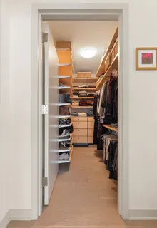 a view of walk in closet with clothes and shoes