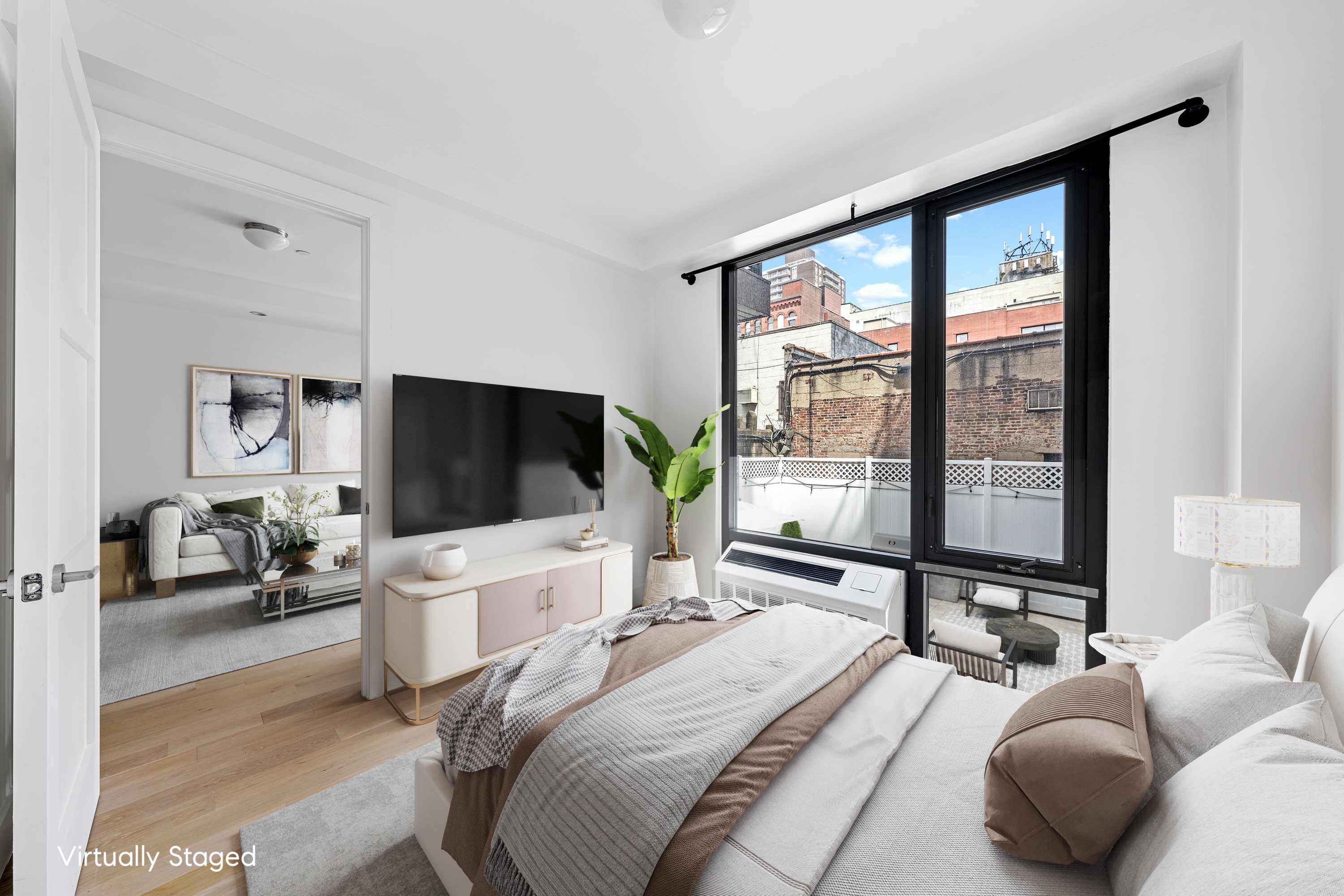 399 East 8th Street, Unit 1A Manhattan, NY 10009 - Photo 5 of 13 a bedroom with a bed and a flat screen tv