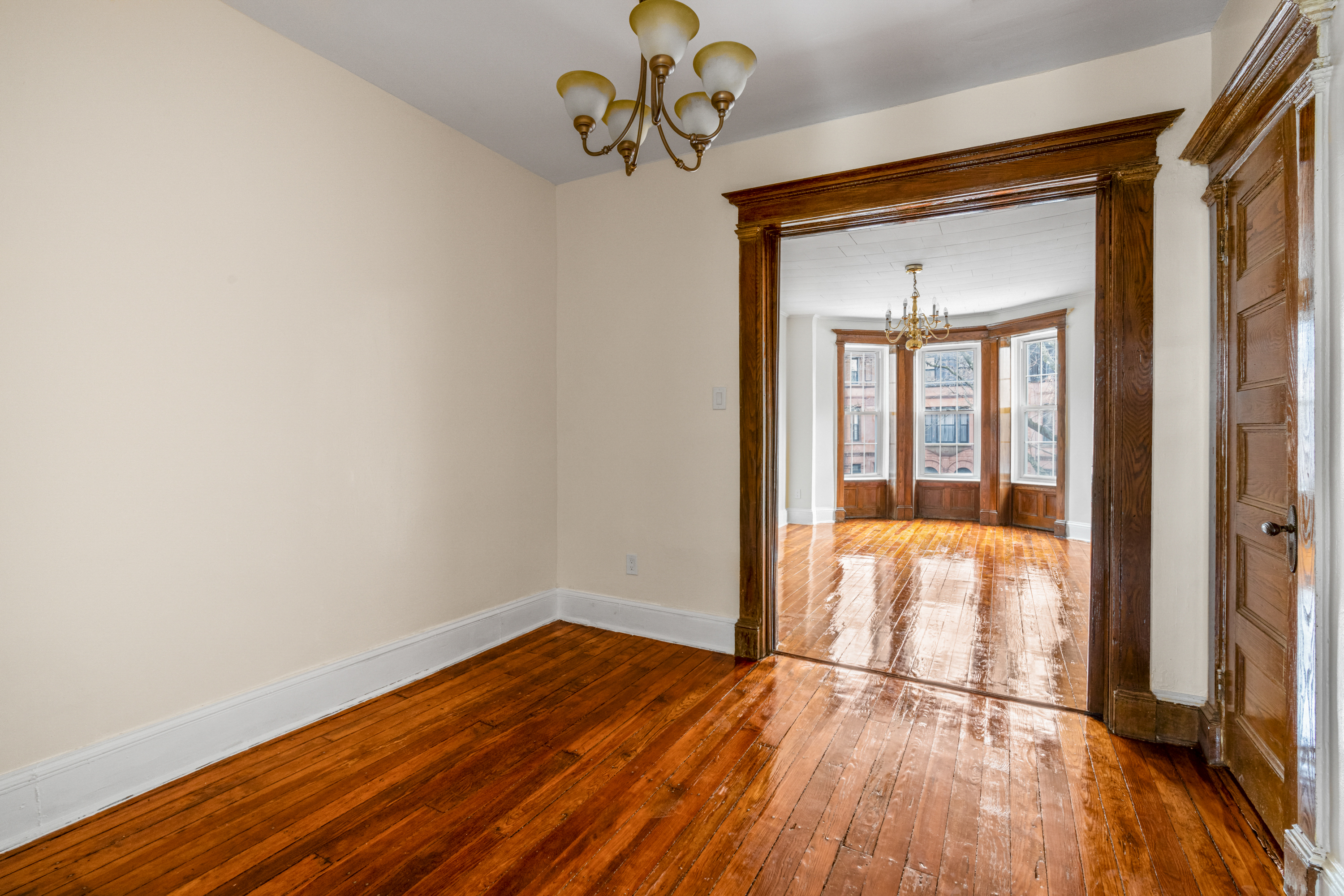 601 Jefferson Avenue, Unit 2 Brooklyn, NY 11221 - Photo 3 of 8 a view of empty room with wooden floor and fan