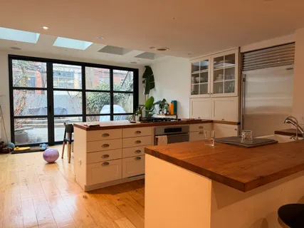 a kitchen with sink stove and cabinets
