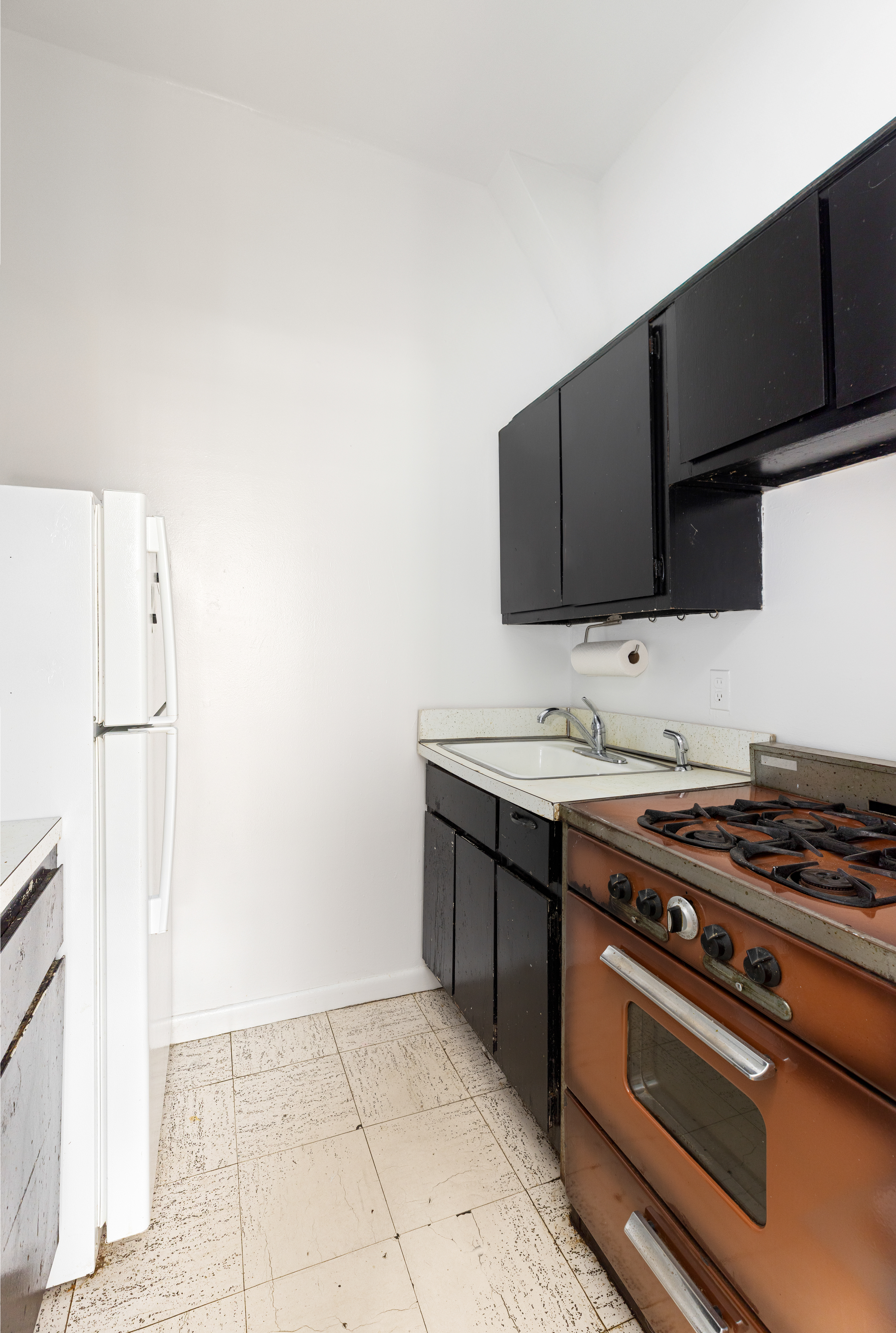 99 Bank Street, Unit 4R Manhattan, NY 10014 - Photo 7 of 15 a kitchen with stainless steel appliances a sink stove and microwave