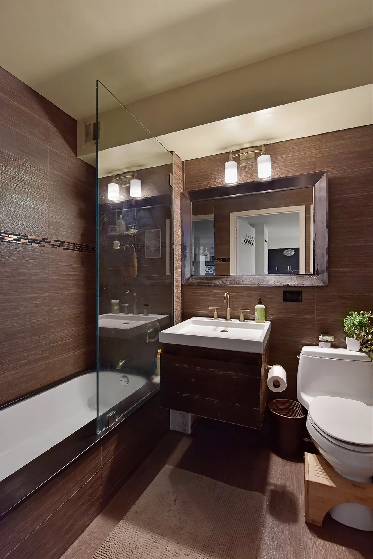 2235 Frederick Douglass Boulevard, Unit 2D Manhattan, NY 10027 - Photo 9 of 14 a bathroom with a sink and mirror with bathtub