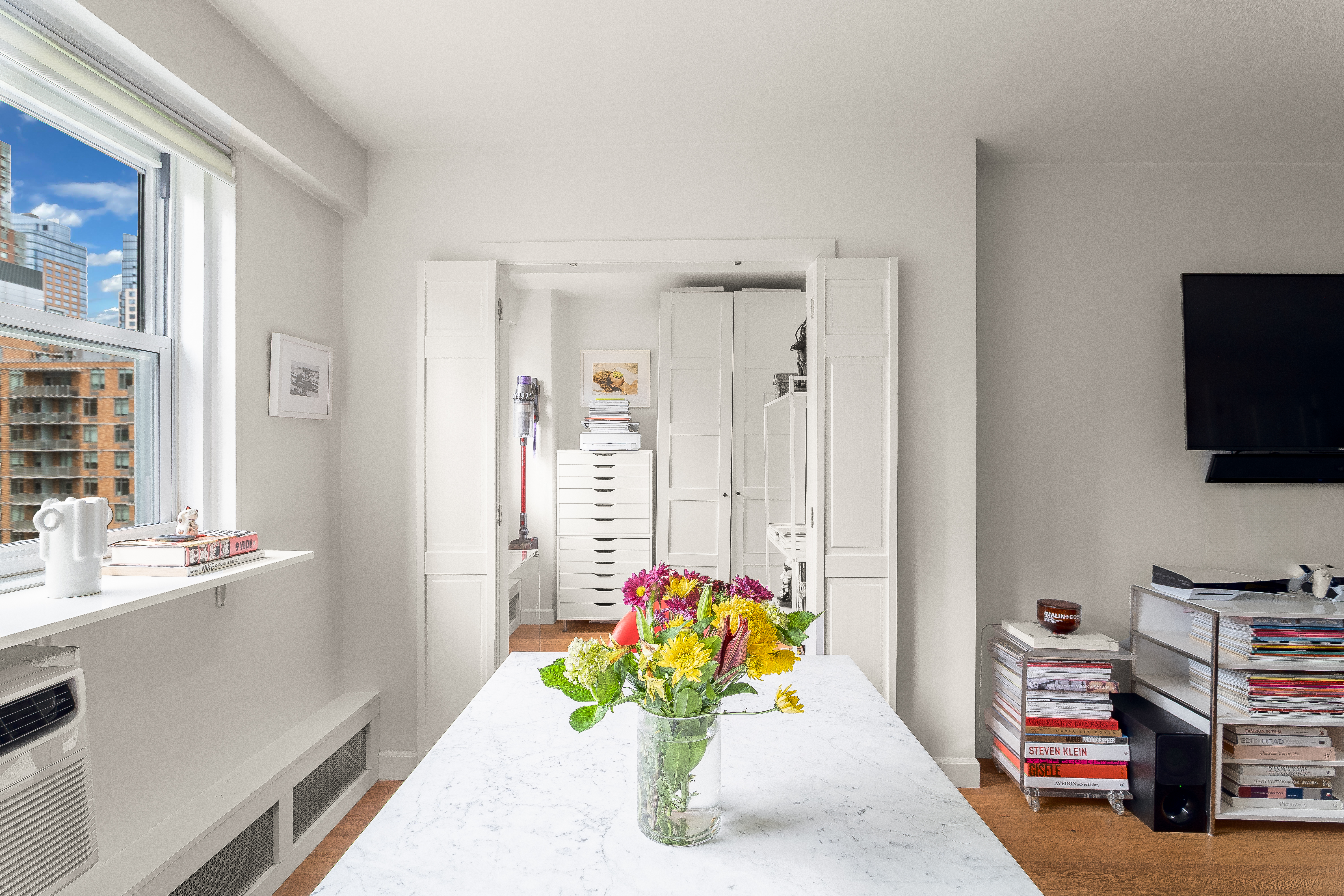191 Willoughby Street, Unit 12J Brooklyn, NY 11201 - Photo 7 of 19 a living room with furniture and a flat screen tv
