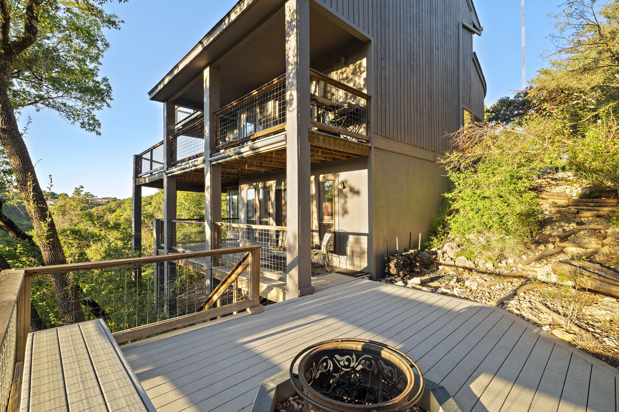 1605 The High Road Austin, TX 78746 - Photo 21 of 45 a view of a balcony with wooden floor and iron fence