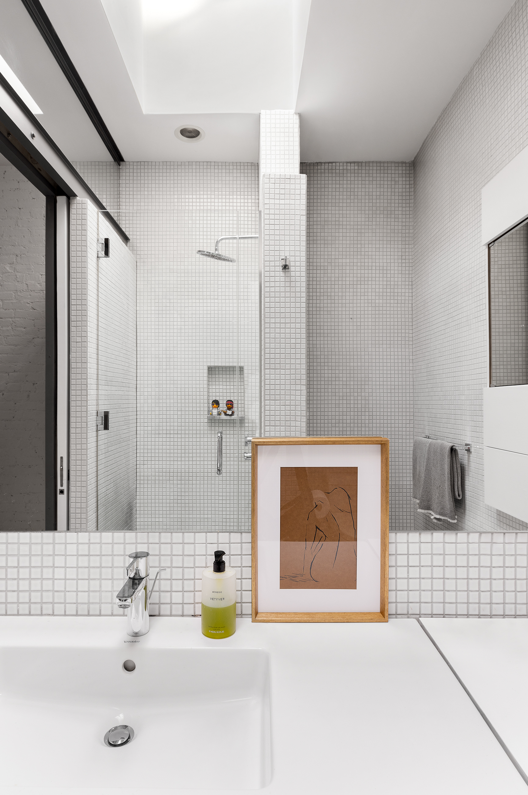281 West 11th Street, Unit 4/5C Manhattan, NY 10014 - Photo 17 of 18 a bathroom with a sink and a mirror