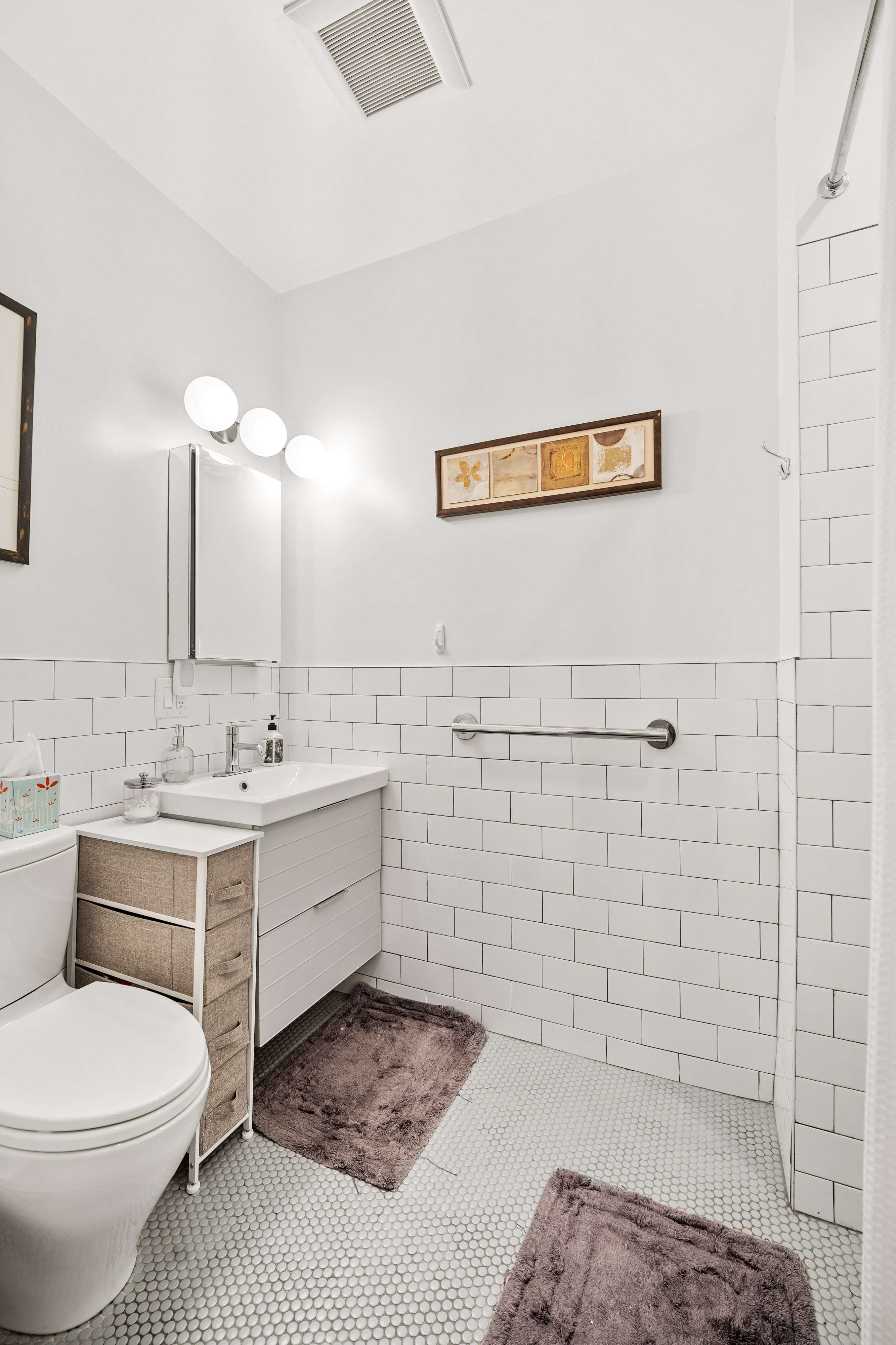 353 12th Street, Unit 2 Brooklyn, NY 11215 - Photo 6 of 17 a bathroom with a sink a toilet and mirror