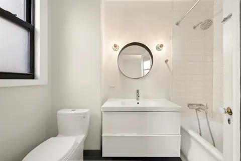 a bathroom with a sink toilet and a mirror