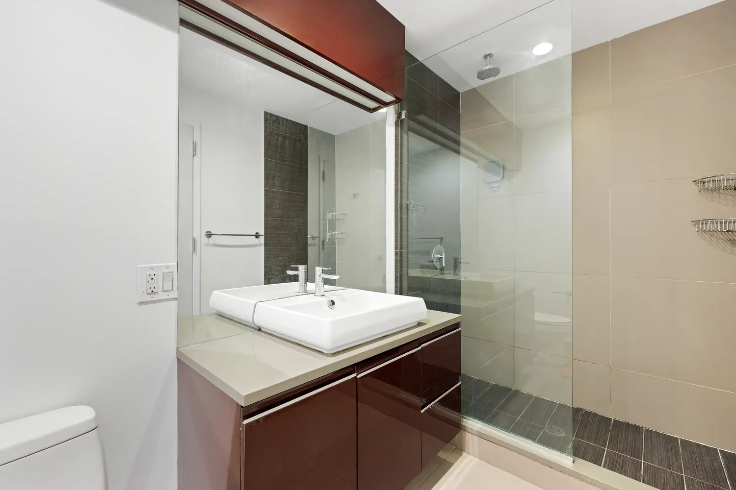 a bathroom with a sink a toilet a mirror and shower