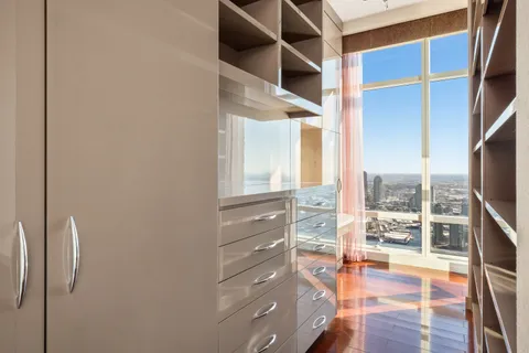 a view of walk in closet with clothes and shoes