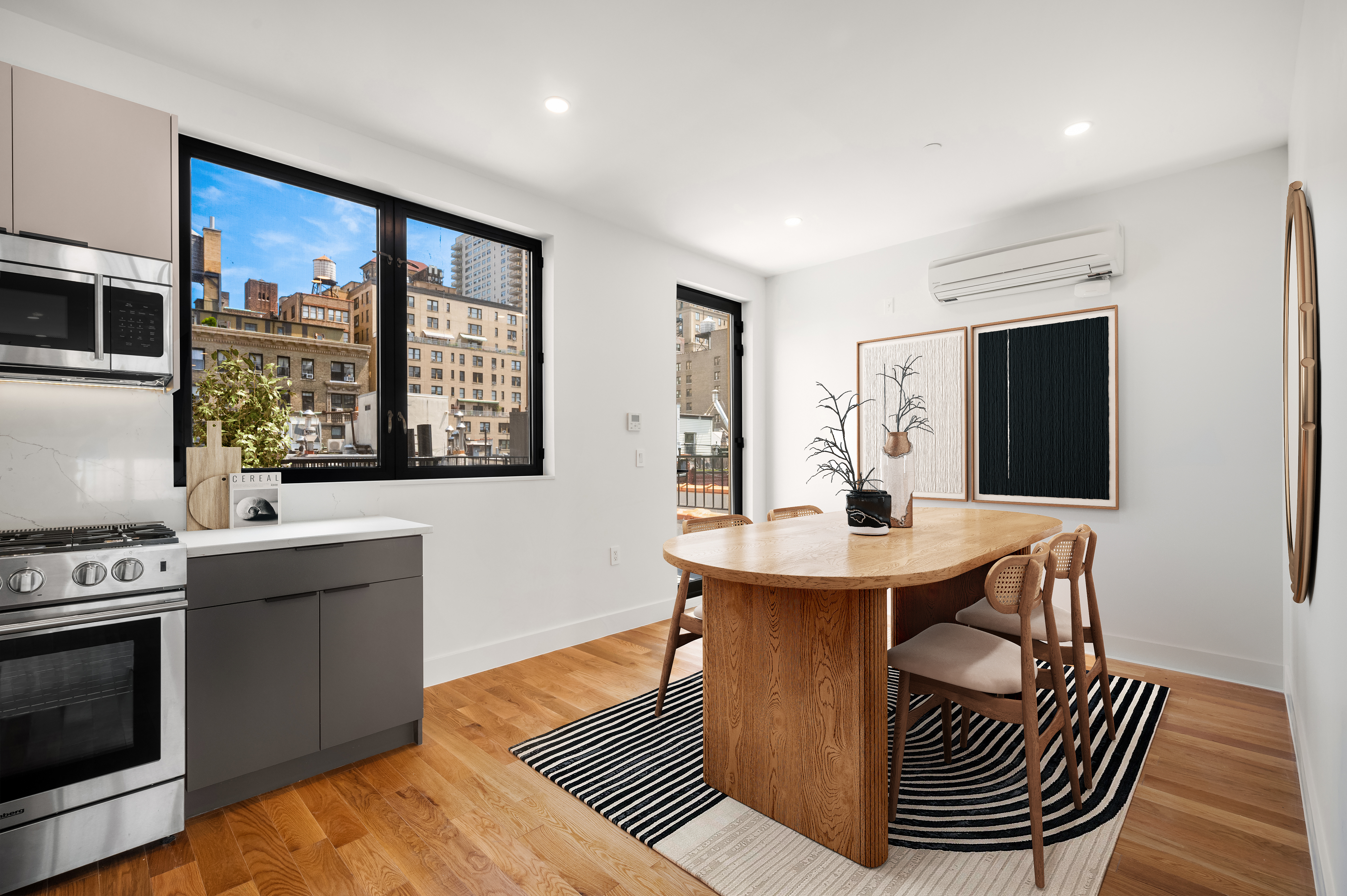 61 West 70th Street, Unit PH Manhattan, NY 10023 - Photo 6 of 18 a dining room with a table chairs and a kitchen view