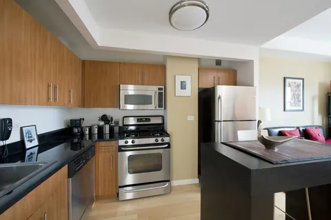 a kitchen with a refrigerator stove and sink