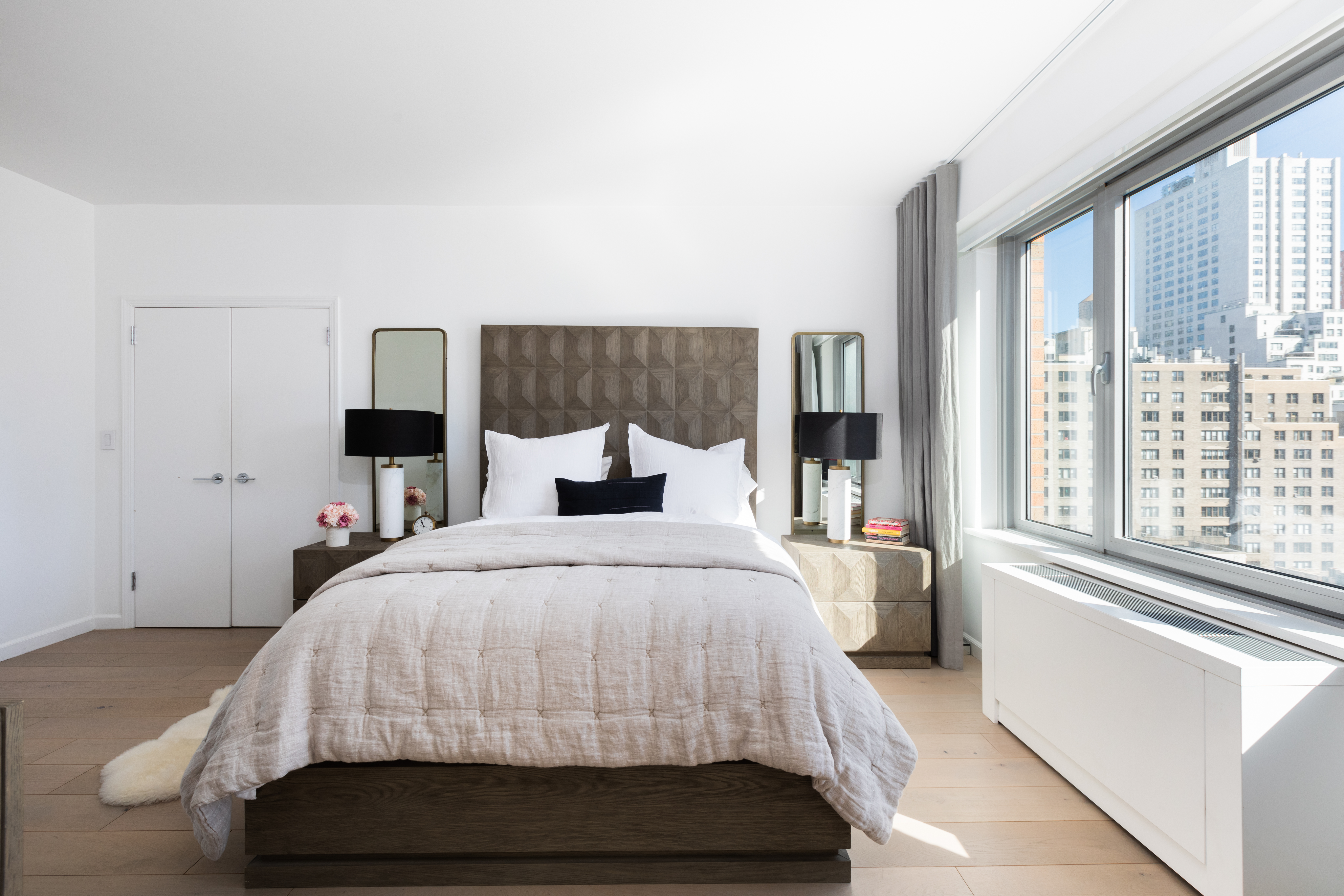 200 East 62nd Street, Unit 10C Manhattan, NY 10065 - Photo 12 of 21 a bedroom with a large bed and a large window