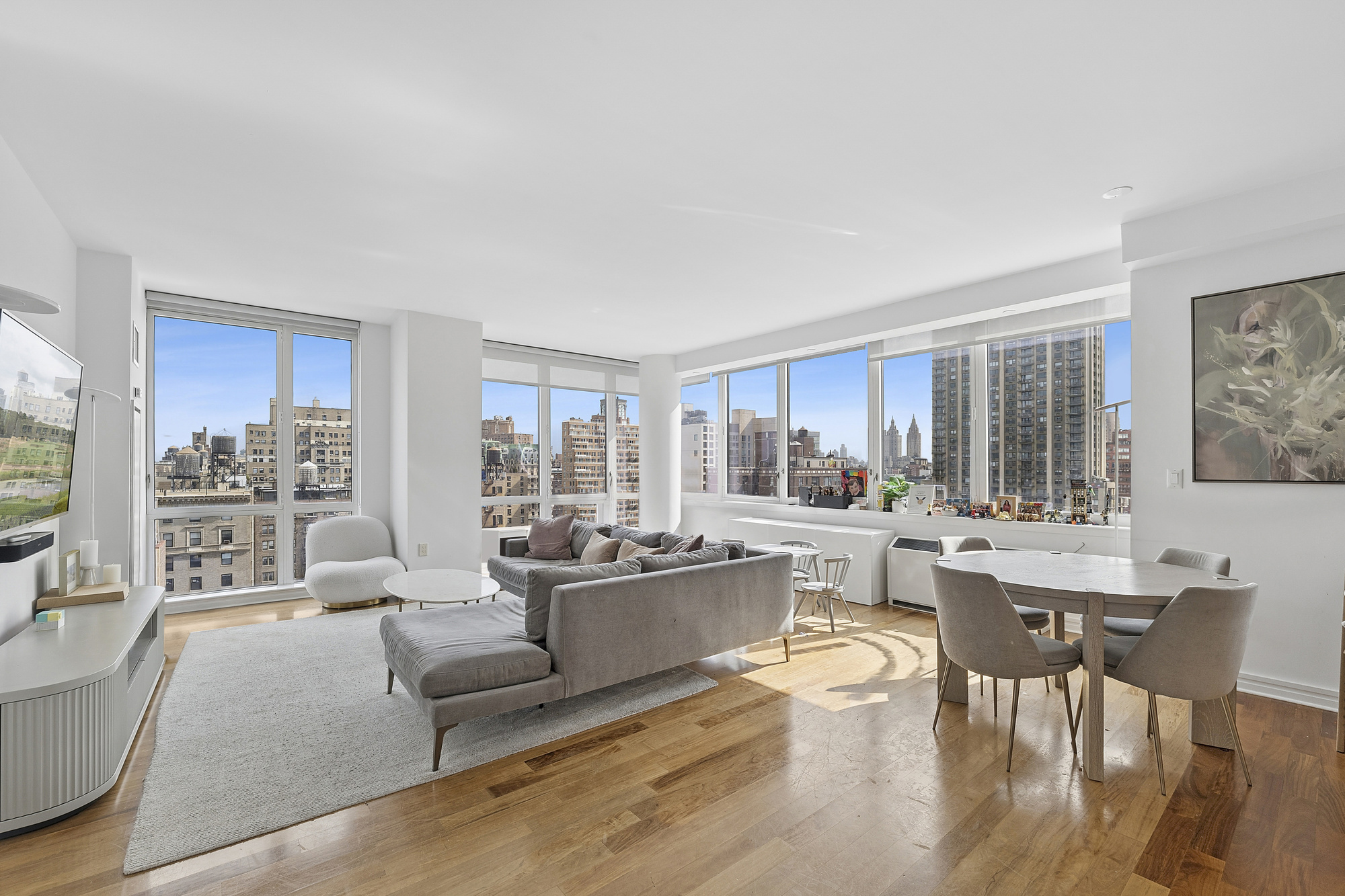 a living room with stainless steel appliances granite countertop furniture and a large window