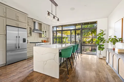 a living room with stainless steel appliances granite countertop furniture and a kitchen view