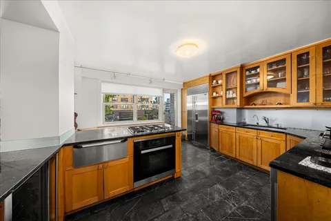 a kitchen with stainless steel appliances granite countertop a stove and a sink