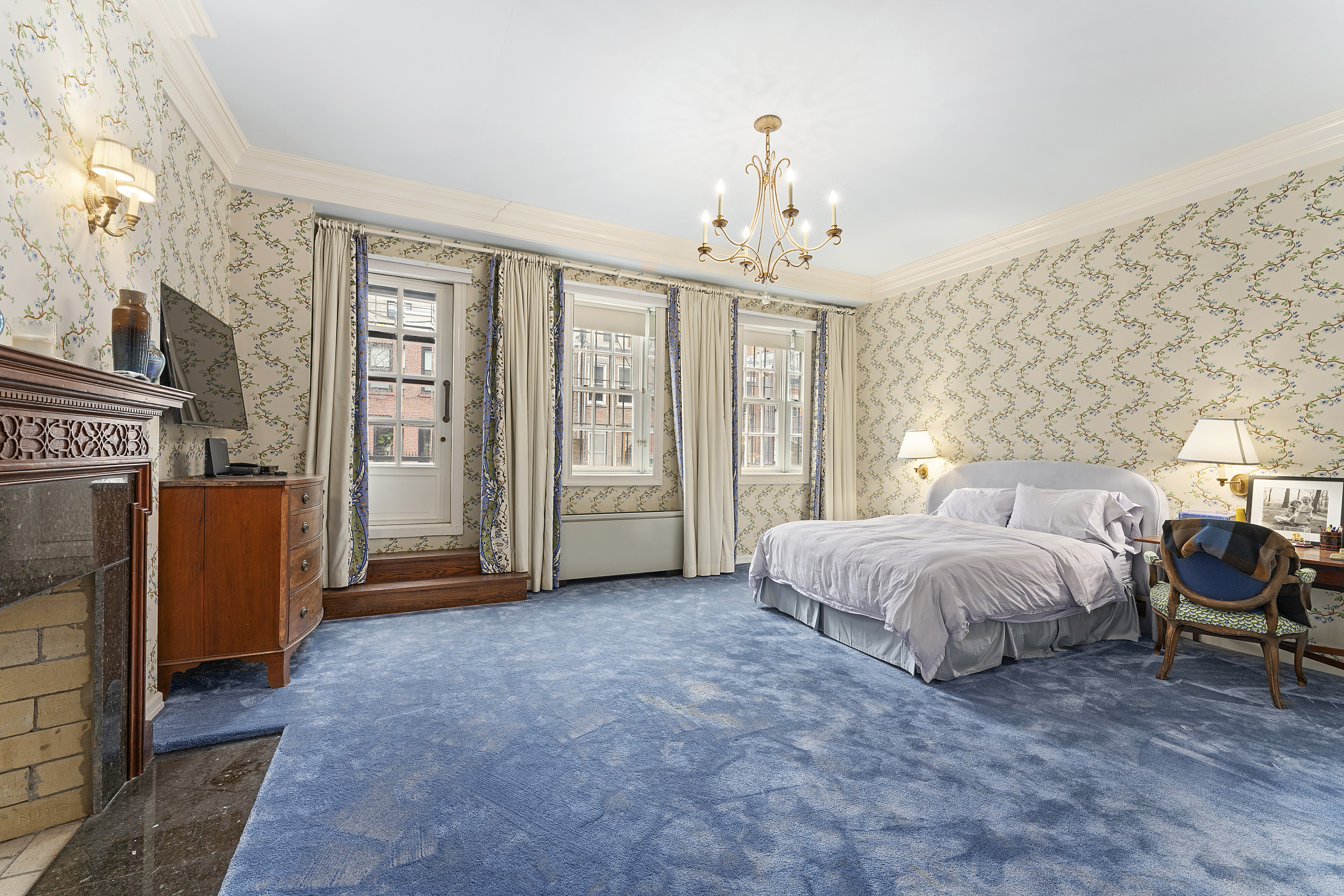 21 West 70th Street Manhattan, NY 10023 - Photo 5 of 12 a spacious bedroom with a bed and a chandelier