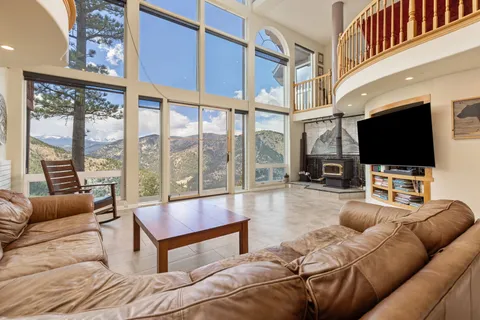 a living room with furniture rug and a large window
