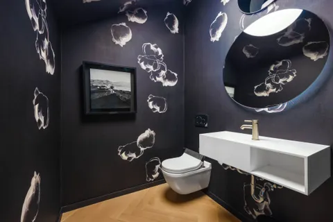 a bathroom with a toilet sink and mirror